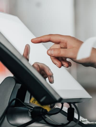 Retail worker uses a point-of-sales system.